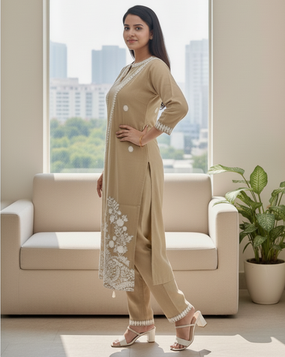 Woman in beige traditional outfit standing in a modern living room with a cityscape view.